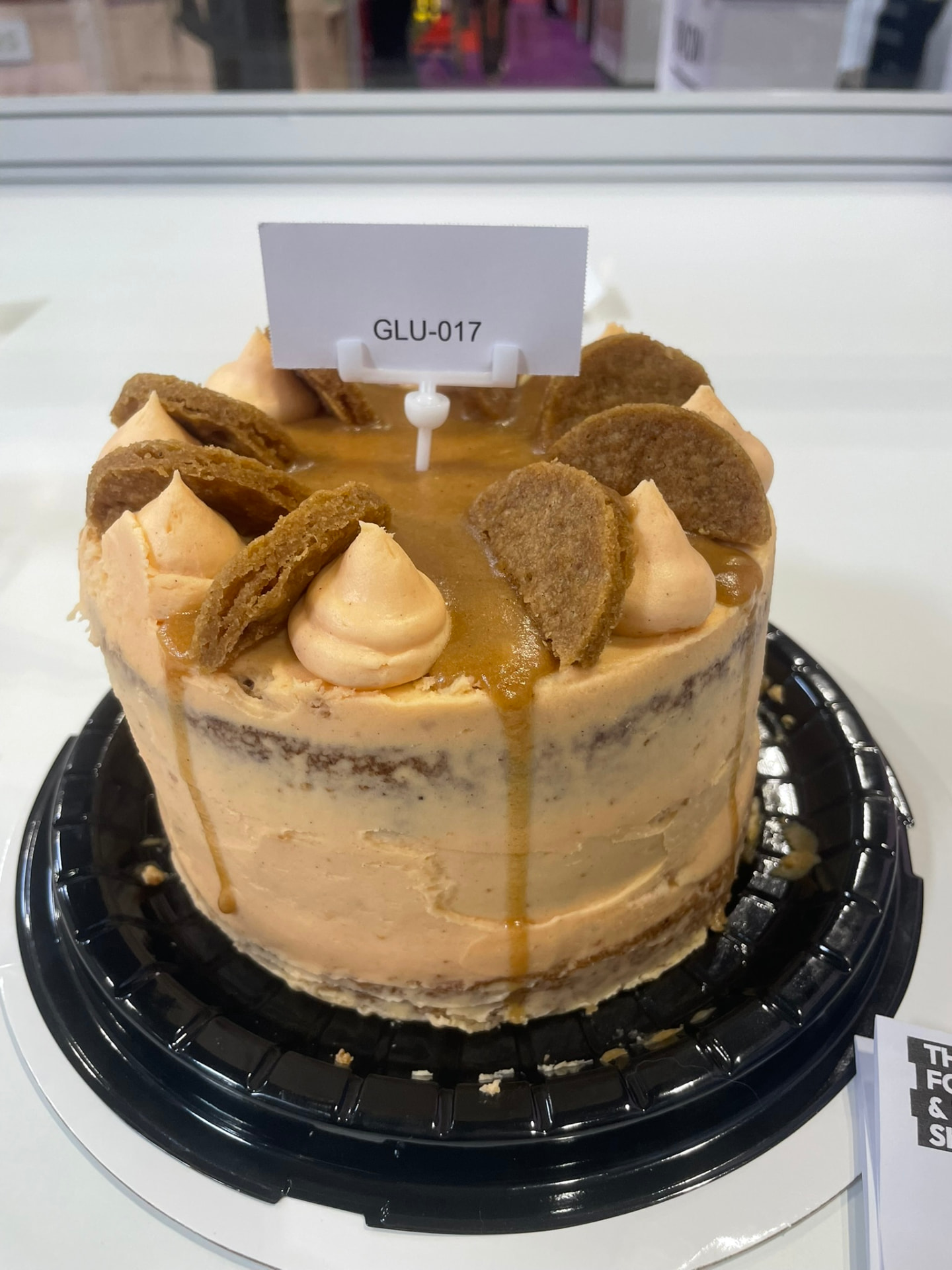 Caramel biscuit layer cake with salted caramel drip and buttercream swirls