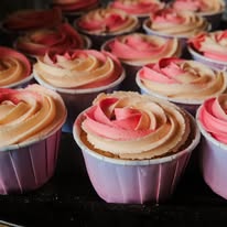 Tray of raspberry ripple cupcakes with swirled pink and vanilla buttercream